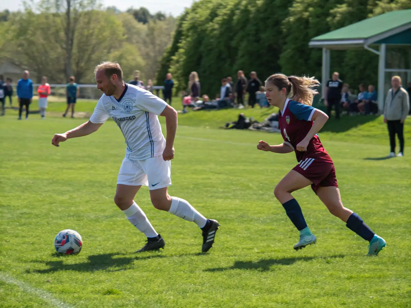 An action shot of teenage players engaged in a competitive football match, showcasing strategic plays and teamwork, with coaches providing guidance from the sidelines.